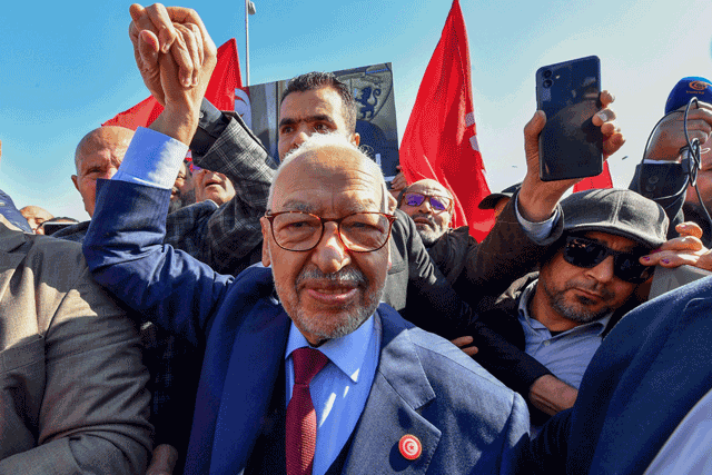 The head of Tunisia’s Islamist movement Ennahdha Rached Ghannouchi greets supporters upon arrival to a police station in Tunis , on Tuesday, in compliance to the summons of an investigating judge (AFP photo)