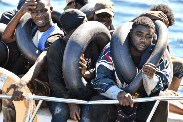 Migrants of African origin trying to flee to Europe are crammed on board of a small boat, as Tunisian coast guards prepare to transfer them onto their vessel, at sea between Tunisia and Italy, on Thursday (AFP photo)