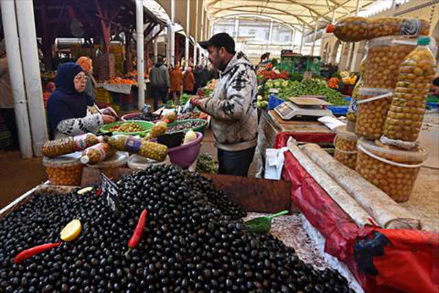 People buy vegetables at the central market ahead of the holy fasting month of Ramadan, in Tunis on Wednesday (AFP photo)