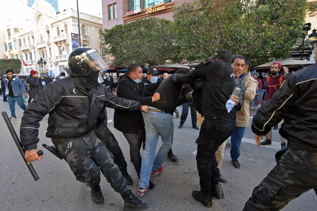Tunisian security officers detain a protester during an anti-government demonstration on the Habib Bourguiba Avenue in the capital Tunis on Tuesday  (AFP photo)