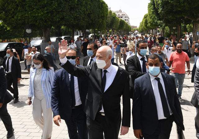 A handout photo provided by the Tunisian Presidency’s official Facebook Page on August 1 shows President Kais Saied (centre) gesturing as he walks protected by security while touring through Habib Bourguiba avenue in the centre of the capital Tunis (AFP photo)