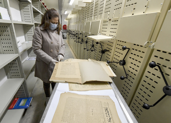 A conservator at the National Library of Tunisia, consults old newspapers, in the institution’s archives in the capital Tunis, on January 26 (AFP photo)