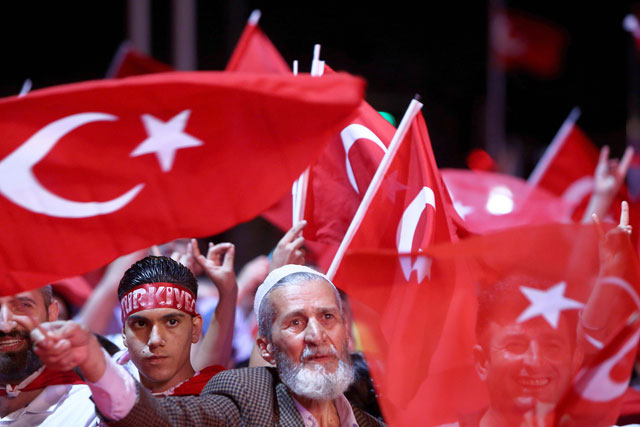 People wave Turkish flags as they take part in an anti-coup rally at Taksim Square in Istanbul, on Tuesday (AP photo)