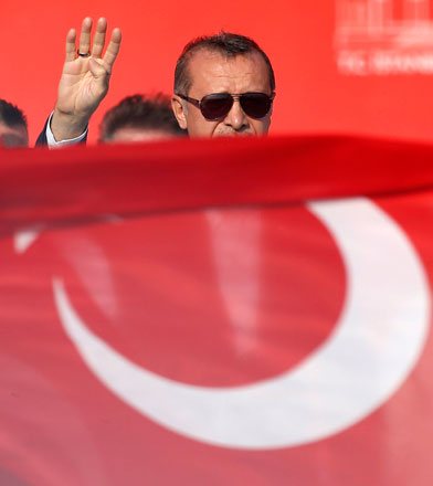 Turkish President Recep Tayyip Erdogan waves to the crowd during a democracy and martyrs’ rally in Istanbul, on Sunday (AP photo)