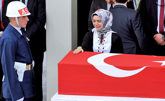 A relative of Army Officer Seckin Cil, who was killed during an operation in Sur district of the southeastern city of Diyarbakir, cries as she stands next to the coffin during the funeral ceremony in Ankara, on Thursday (AFP photo)