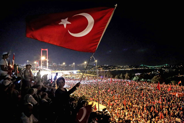 A pro-Erdogan supporter waves a Turkish national flag during a rally at Bosphorus Bridge in Istanbul on  Thursday (AFP photo)