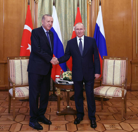 Russian President Vladimir Putin (right) shakes hands with Turkish President Recep Tayyip Erdogan  during a meeting in Sochi, on Friday (AFP photo)