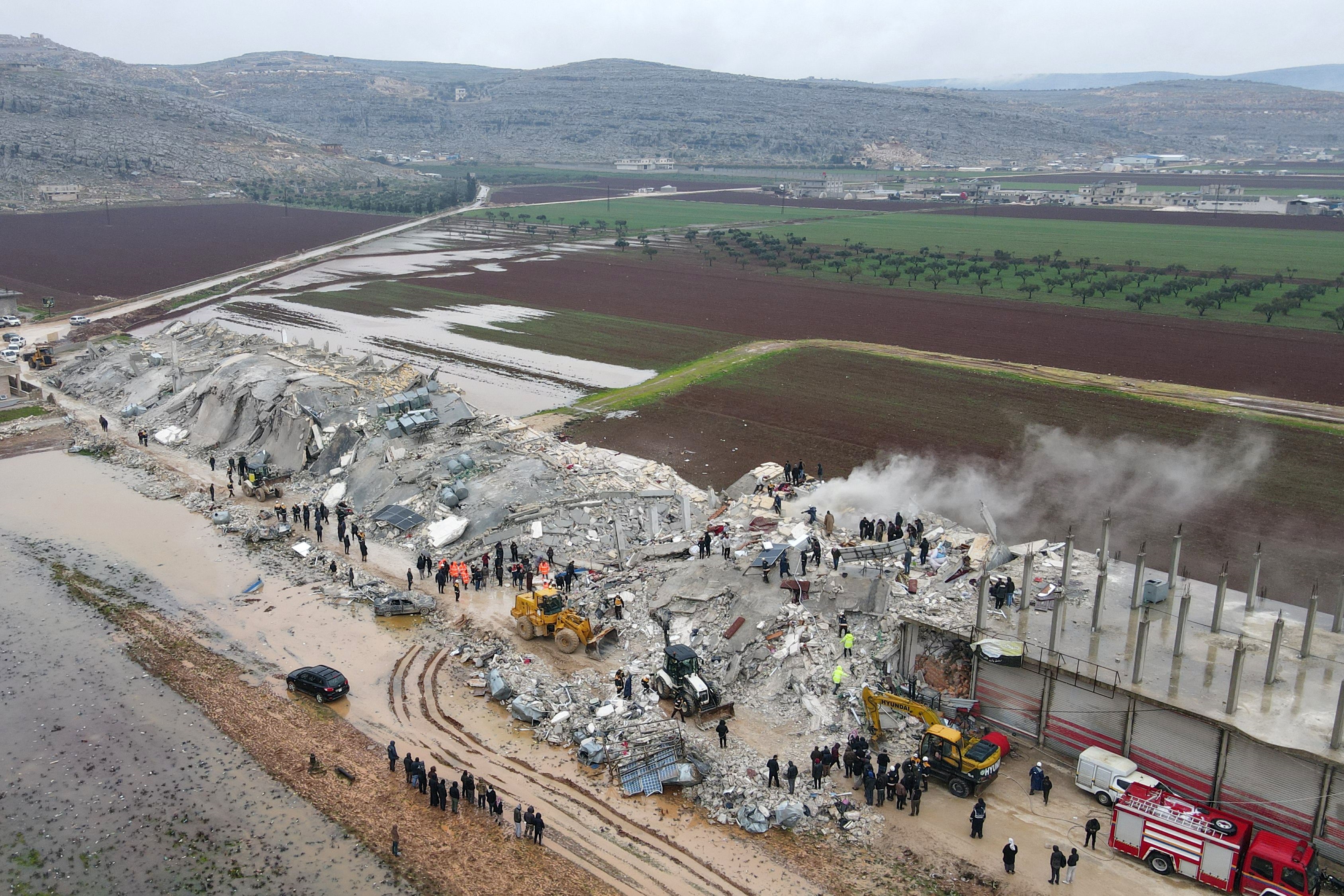 This aerial view shows residents helped by bulldozers, searching for victims and survivors in the rubble of collapsed buildings, following an earthquake in the town of Sarmada in the countryside of the northwestern Syrian Idlib province, early on Monday (AFP photo)