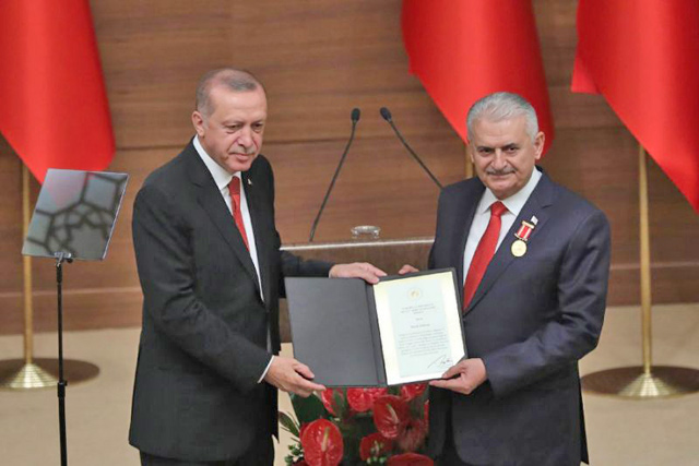 Turkey’s President Recep Tayyip Erdogan (left) awards Binali Yildirim the Order of Merit on July 13 (AFP photo) 