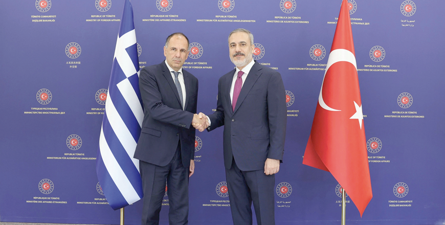 This handout photo, taken and released by the Turkish foreign ministry on Tuesday, shows Turkey's Foreign Minister Hakan Fidan (right) shaking hands with Greece Foreign Minister Giorgos Gerapetritis during a meeting in Ankara (AFP photo)