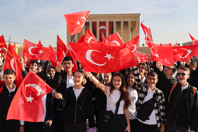 People wave the national flag in front of the mausoleum of Mustafa Kemal Ataturk, the founder of the Republic of Turkey, during the 100th Anniversary of the Republic of Turkey in Ankara on Sunday (AFP photo)