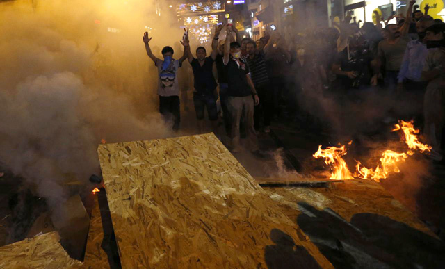 Protesters light a fire as they block a road during clashes with riot police at Istiklal Street in central Istanbul late on July 13, 2013 (Reuters photo)