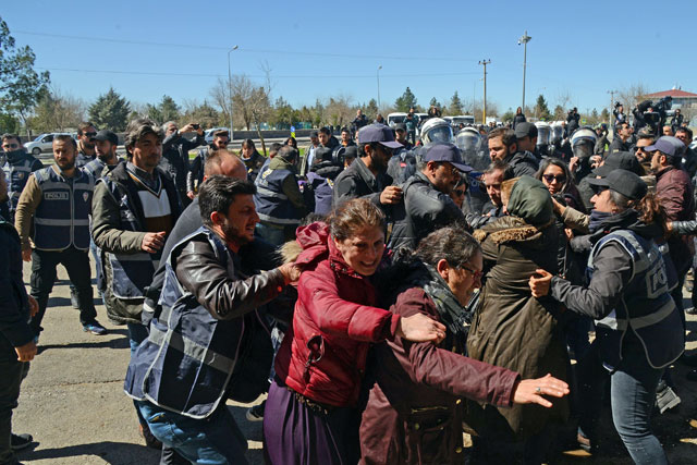 Turkish anti-riot police officers detain a protester during Kurdish activist Zulkuf Gezen funeral in the Turkish city of Diyarbakir on Monday (AFP photo)