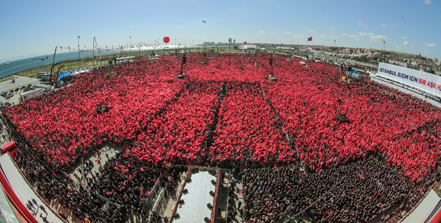 People wave flags as they attend a campaign rally of the People's Alliance, which gather the Justice and Development Party and right-wing Nationalist Movement Party, in Istanbul on Sunday (AFP photo)