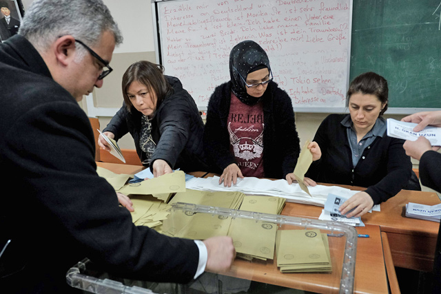 Scrutinisers count ballots at a polling station in Istanbul on Sunday  (AFP photo)