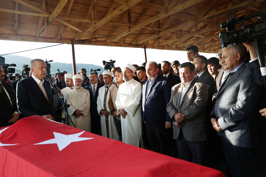 This handout photo released by the Press Office of the Presidency of Turkey on Saturday, shows Turkish President Recep Tayyip Erdogan speaking as he attends the funeral of Ramazan Ozcelik, who lost his life during an explosion in a coal mine, in Makaraci village in Amasra district, in Turkey's Bartin Province (AFP photo)