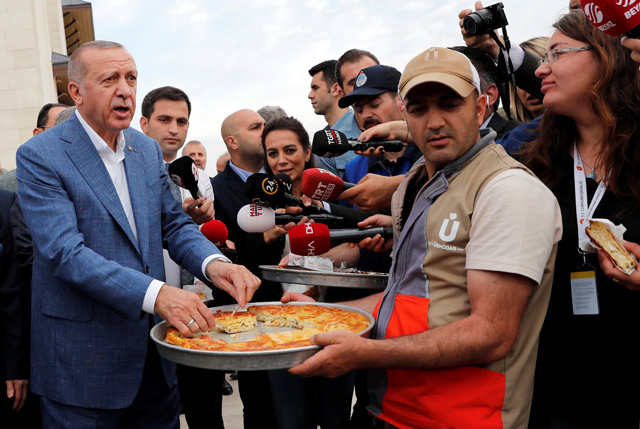 Turkish President Recep Tayyip Erdogan meets with reporters after the Eid Al Fitr prayers to mark the end of the holy month of Ramadan in Istanbul, Turkey, on Tuesday (Reuters photo)