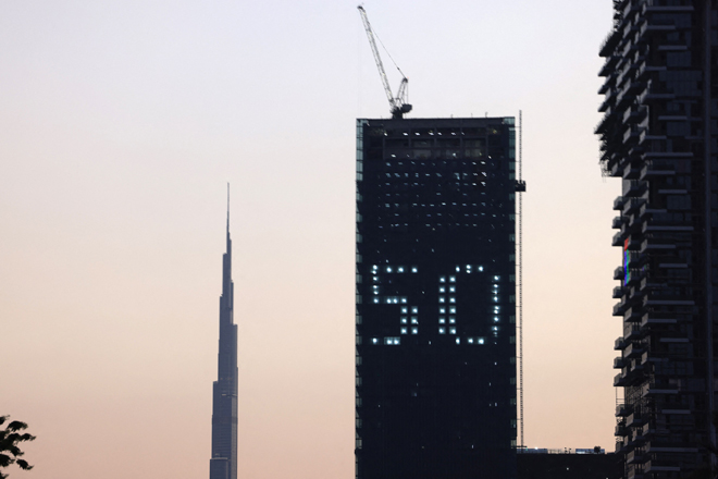 The number 50 is displayed on a building in the Gulf emirate of Dubai with the Burj Khalifa in the background, on Monday, celebrating the upcoming United Arab Emirates' 50th anniversary which falls on December 2 (AFP photo)