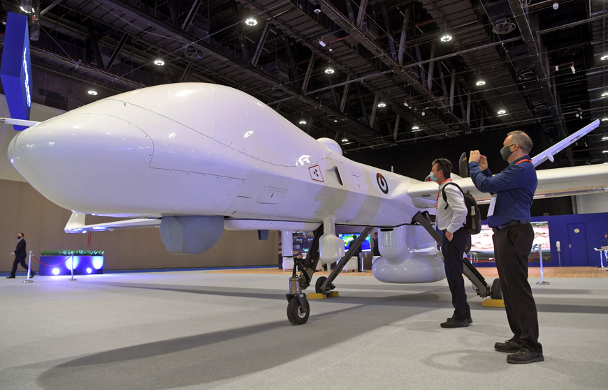 Visitors view a MQ-9B Sea Guardian Drone by General Atomics Auronautical on display at the UMEX Exhibition showcasing drones, robotics, and unmanned sytems at the Abu Dhabi National Exhibition Centre in the gulf emirate, on Tuesday (AFP photo)