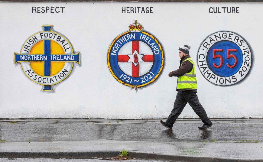 A man walks past a mural in Belfast, Northern Ireland, on Monday (AFP photo)