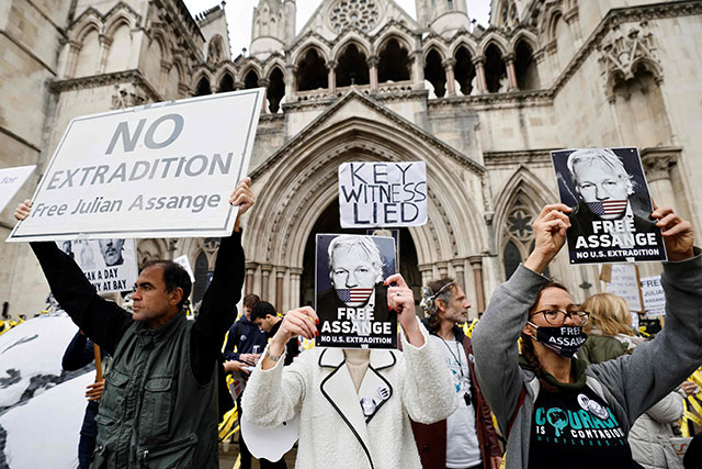 Protesters hold placards during a demonstration outside the Royal Courts of Justice in London on Thursday, the second day of an appeal hearing by the US government against the UK's refusal to extradite WikiLeaks founder Julian Assange (AFP photo)