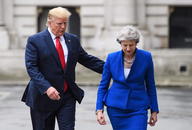 Britain's Prime Minister Theresa May (right) and US President Donald Trump walk through the Quadrangle of the Foreign and Commonwealth Office for a joint press conference in central London on Tuesday on the second day of the US president's state visit  (AFP photo)