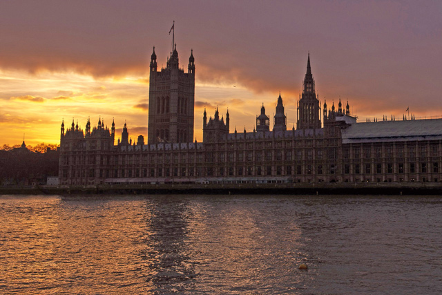 The sun sets behind The Palace of Westminster, home of the British Houses of Parliament in central London, on Friday (AFP photo)