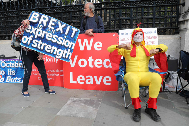 Protesters hold placards aloft near the houses of parliament in central London on Thursday (AFP photo)