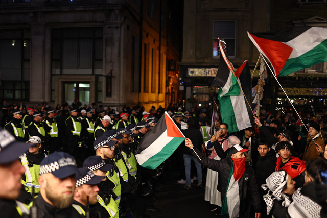 Police officers form a line to stop protesters moving on, during a 'National March For Palestine' in central London on Saturday (AFP photo)