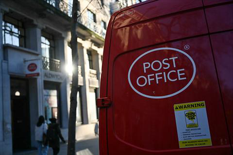A photograph taken on Friday shows a Post office van parked in front of a Post Office sign, in London. (AFP photo)