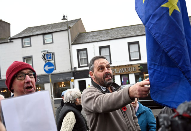 A pro-Brexit man (right) argues with a group of anti-Brexit demonstrators after Brexit Party leader Nigel Farage addressed an election campaign event in Workington, Cumbria, on Wednesday (AFP photo)