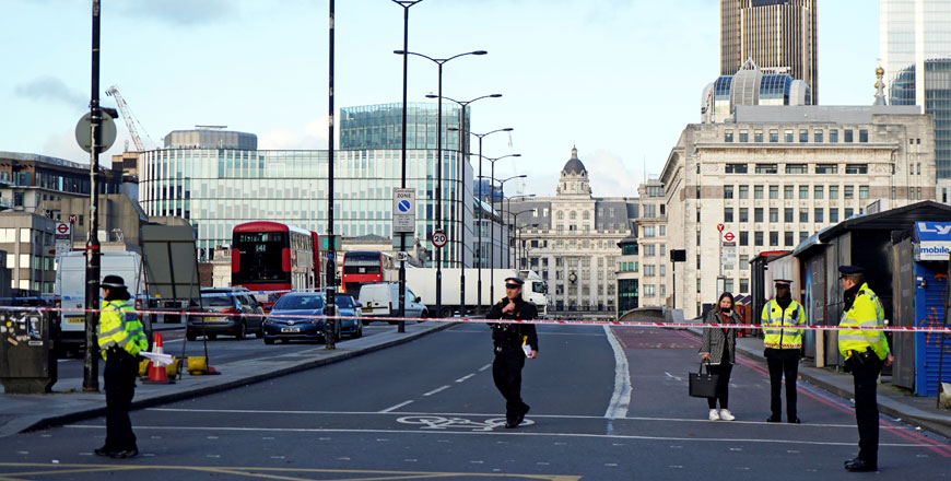 British police officers stand on duty at the southern entrance to London Bridge, leading to the City of London, on Saturday (AFP photo)