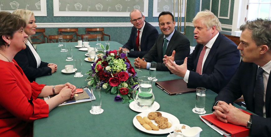 Northern Ireland's First Minister Arlene Foster and Deputy First Minister Michelle O'Neill, Ireland's Foreign Minister Simon Coveney, Ireland's Prime Minister Leo Varadkar, Britain's Prime Minister Boris Johnson and Britain's Northern Ireland Secretary Julian Smith talk during their meeting at the parliament buildings, the seat of the Northern Ireland Assembly, on the Stormont Estate in Belfast, on Monday (AFP photo)