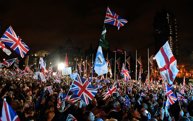 Brexit supporters wave union flags as they gathered in Parliament Square, the venue for the leave means leave Brexit celebration in central London on Friday, the day that the UK formally leaves the European Union (AFP photo)
