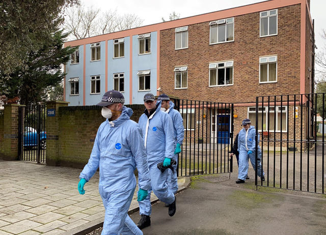 Police officers conduct a search of a bail hostel in south London on Monday (AFP photo)