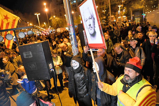 Demonstrators take part in a protest called by Catalan National Assembly under the motto ‘Journalism is not a crime’ to support WikiLeaks founder Julian Assange in Barcelona on Monday (AFP photo)