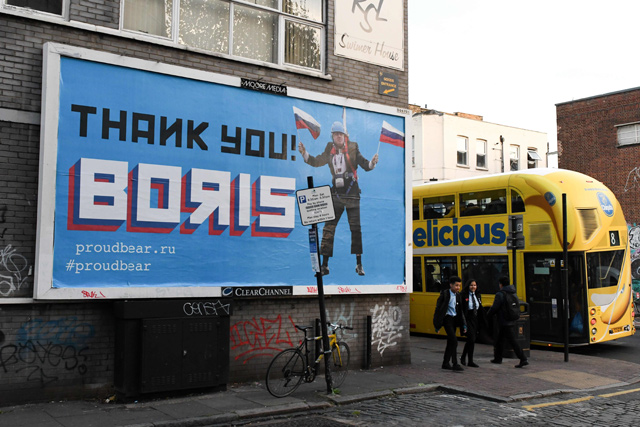 In this file photo taken on November 8, 2018, a Brexit-themed billboard depicting Britain’s former foreign secretary Boris Johnson waving Russian national flags reading ‘Thank you Boris’ is seen in east London  (AFP photo)