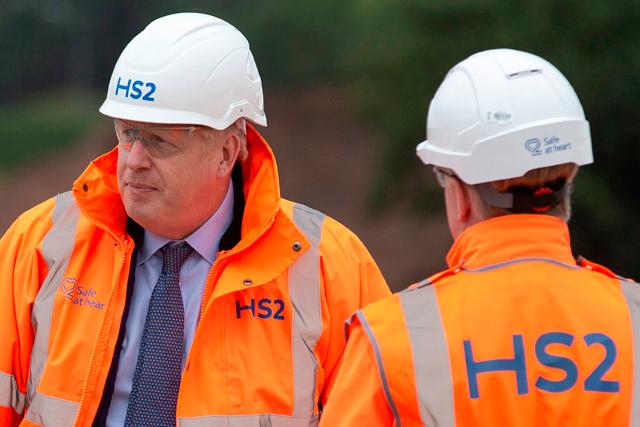 Britain's Prime Minister Boris Johnson (left) reacts during his visit to the Solihull Interchange construction site for the HS2 high-speed railway project, near Birmingham, central England, on Friday (AFP file photo)