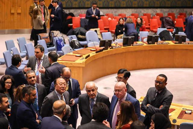 Palestinian Ambassador to the UN Riyad Mansour (centre), China's ambassador to the UN Zhang Jun (centre left), and Russian Permanent Representative to the UN Vassily Nebenzia (centre right) talk in the chamber during a UN Security Council meeting on the situation in the Middle East including the Palestinian question, at UN headquarters in New York on Tuesday (AFP photo)