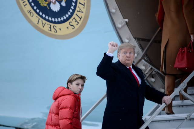 In this file photo taken on Friday, US President Donald Trump and son Barron Trump board Air Force One at Andrews Air Force Base in Maryland, en route to Palm Beach, Florida (AFP photo)