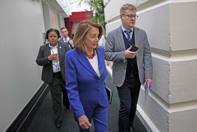 US Speaker of the House Nancy Pelosi (centre) walks to a weekly caucus meeting of House Democrats in the US Capitol in Washington, DC, on Tuesday (AFP photo)