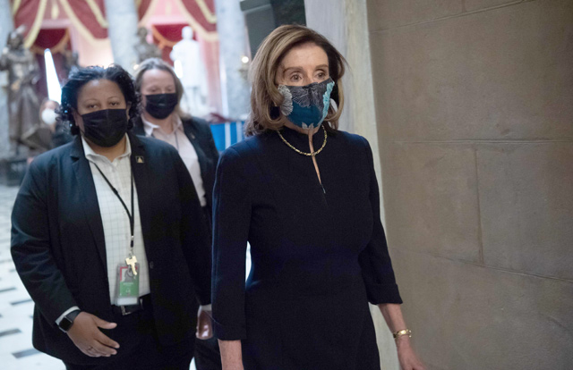 Speaker of the House Nancy Pelosi walks to her office after speaking on the House floor at the US Capitol in Washington, DC, on Wednesday, ahead of an expected House vote impeaching US President Donald Trump (AFP photo)