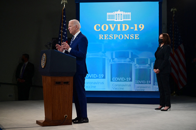 US President Joe Biden, with Vice President Kamala Harris (right), delivers remarks on Covid-19 response and vaccinations in the South Court Auditorium of the White House in Washington DC, on Tuesday (AFP photo)