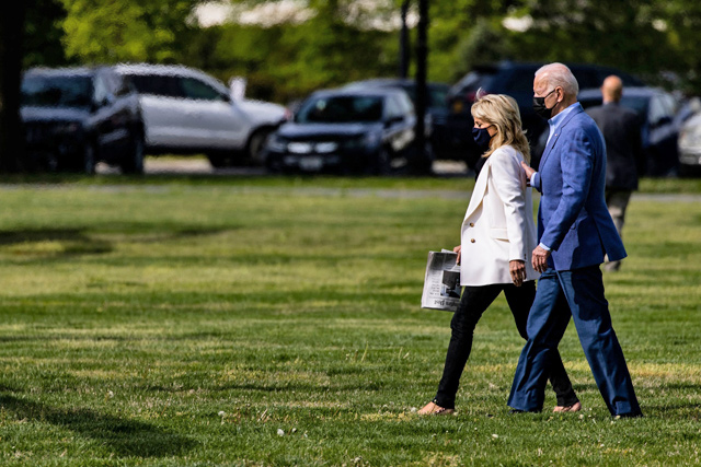US President Joe Biden and First Lady Jill Biden walk across the Ellipse next to the White House towards Marine One in Washington, DC, on Saturday  (AFP photo)