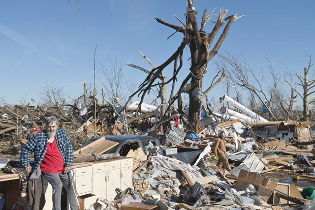 Bogdan Gaicki surveys tornado damage after extreme weather hit the region on Sunday, in Mayfield, Kentucky (AFP photo)