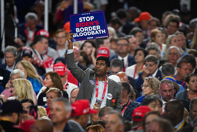 An attendee holds up a sign reading ‘Stop Biden's Border Bloodbath’ on the second day of the Republican National Convention at the Fiserv Forum on Tuesday in Milwaukee, Wisconsin (AFP photo)