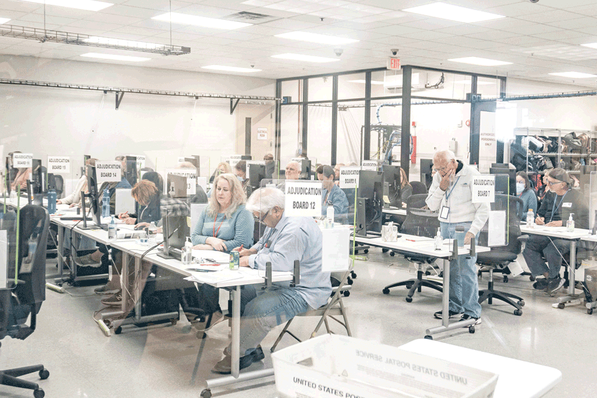 Election workers handle ballots for the US midterm election, in the presence of observers from both Democrat and Republican parties, at the Maricopa County Tabulation and Elections Centre (MCTEC) in Phoenix, Arizona, on Wednesday (AFP photo)