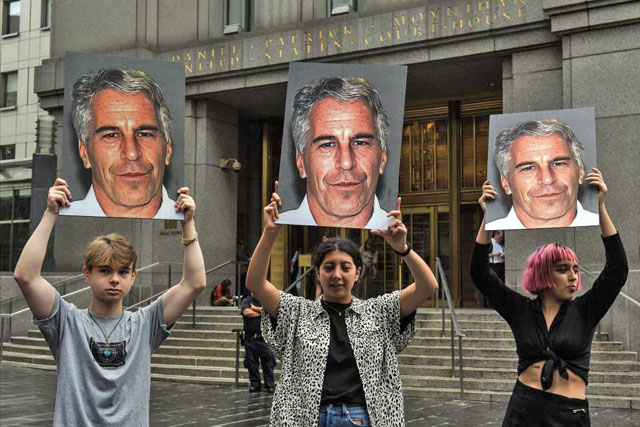 A protest group called ‘Hot Mess’ hold up signs of Jeffrey Epstein in front of the federal courthouse in New York City in July 8, in New York City (AFP photo)