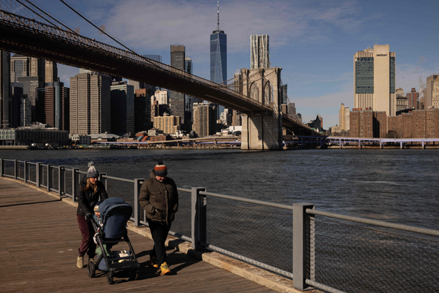 A family walks near the Brooklyn Bridge on Saturday in New York, where temperatures were expected to reach a high of -3oC (AFP photo)