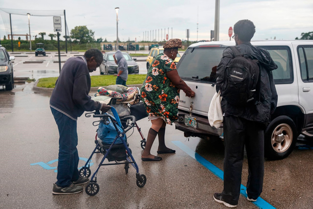 With the evacuation of St Lucie county lifted, residents who have been staying in the shelter at Fort Pierce High School leave to return to their homes on Wednesday (AFP photo)